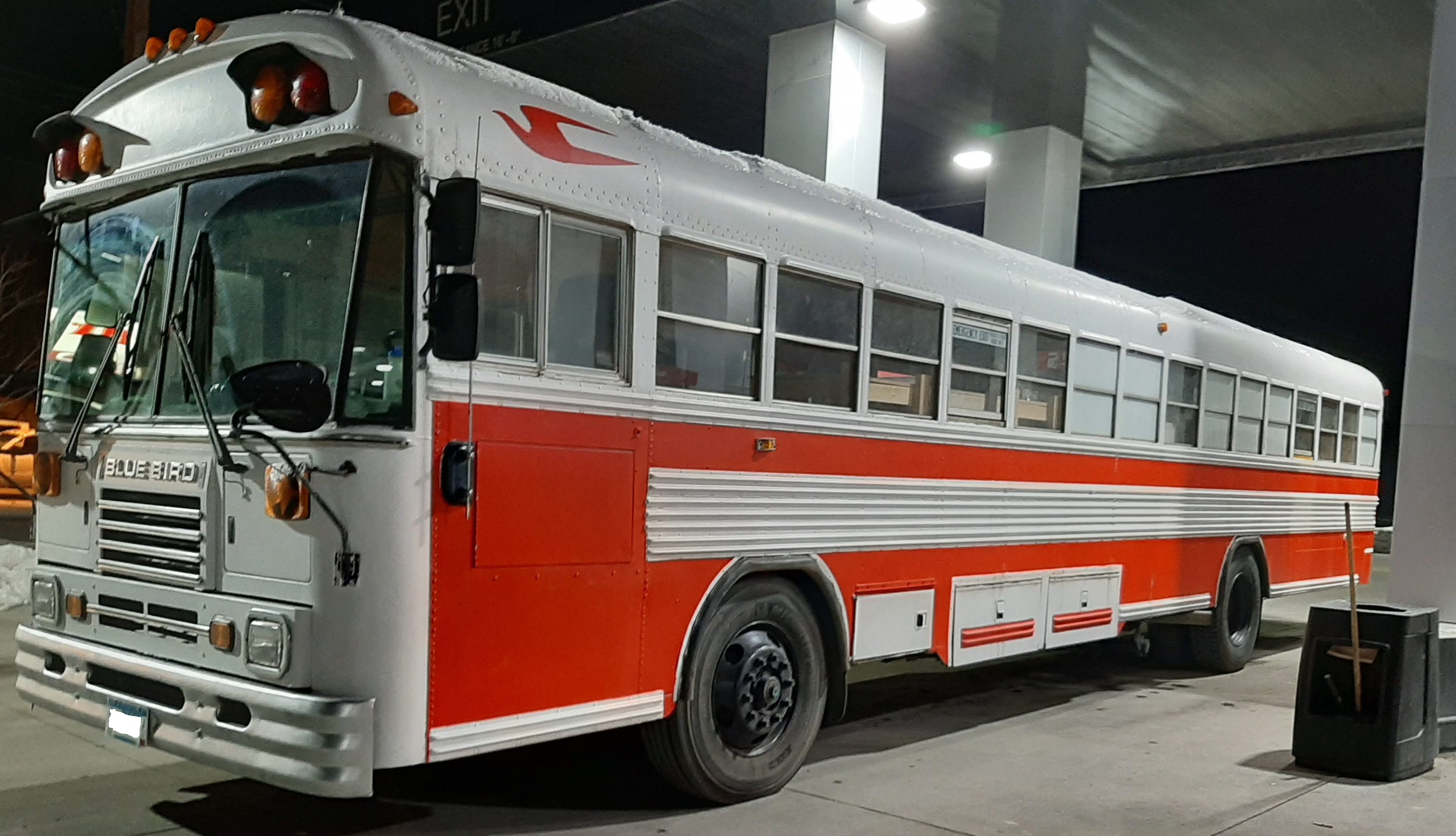 The Finished bus parked at a gas station